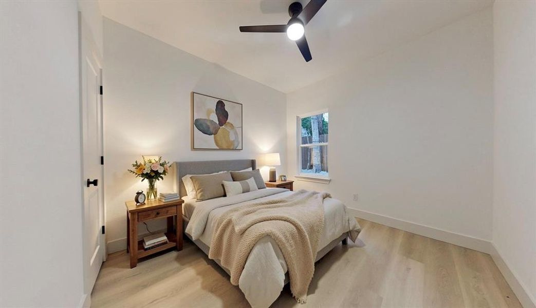 Bedroom featuring light wood-finish flooring, white walls, and a contemporary ceiling fan