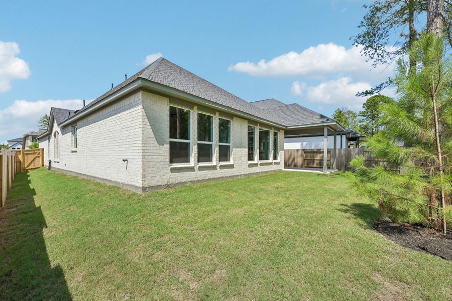 Exterior details and patio area of a home in Woodhavyn 50', Magnolia (Image 17).