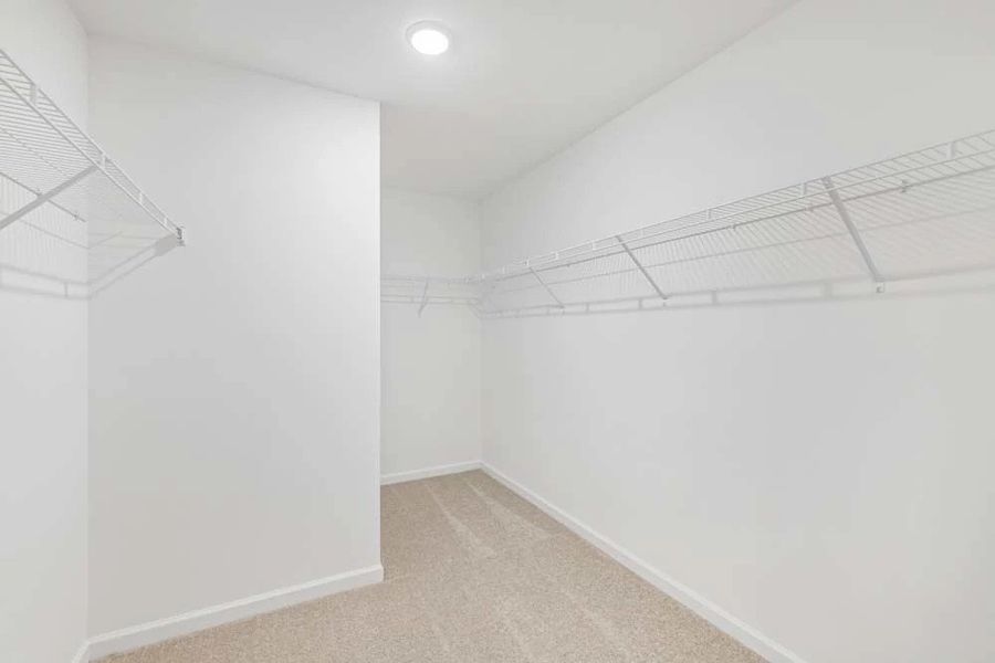 Sample Photo: Primary Bedroom Walk-In Closet Sample Photo: Primary Bedroom Walk-In Closet