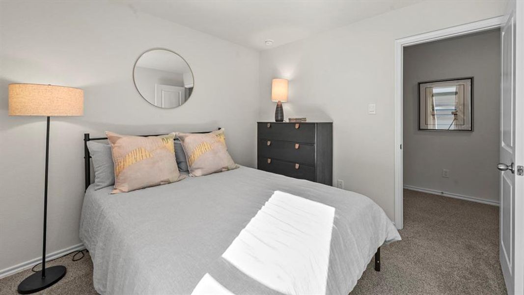 Bedroom featuring light carpet and baseboards