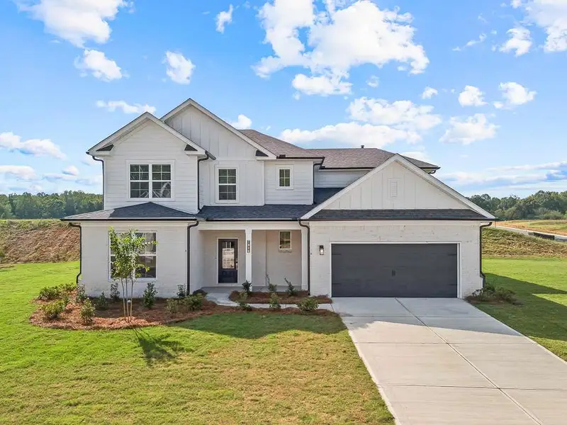 Front exterior of a new home in Ellorie Estates, Dawsonville, GA, highlighting curb appeal (Image 2). Front exterior of a new home in Ellorie Estates, Dawsonville, GA, highlighting curb appeal (Image 2).