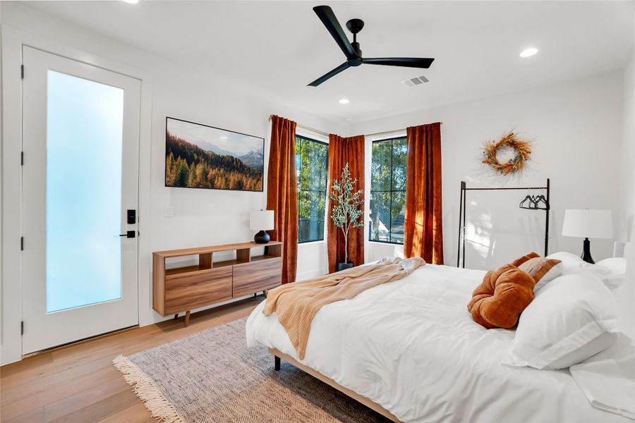 Bedroom featuring wood finished floors, a ceiling fan, and recessed lighting Bedroom featuring wood finished floors, a ceiling fan, and recessed lighting