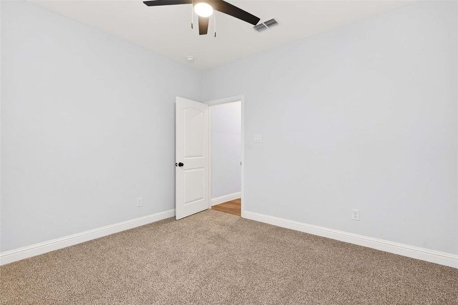 Spare room with carpet flooring and ceiling fan