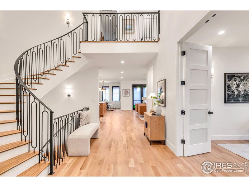 Stunning entry with elegant curved staircase connecting all 3 levels