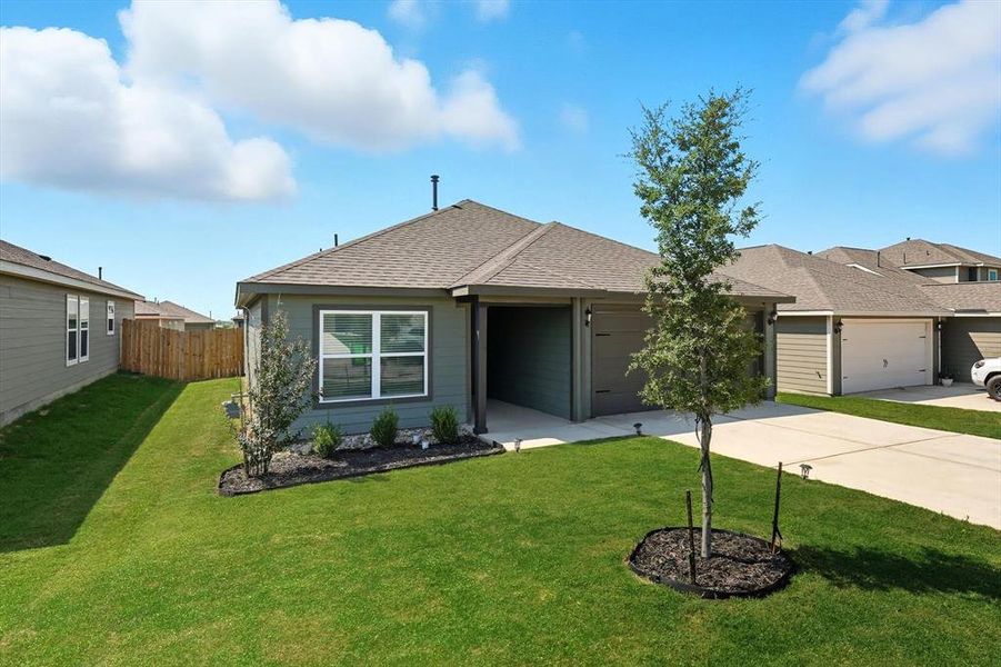 View of front of house with a shingled roof, driveway, and a garage