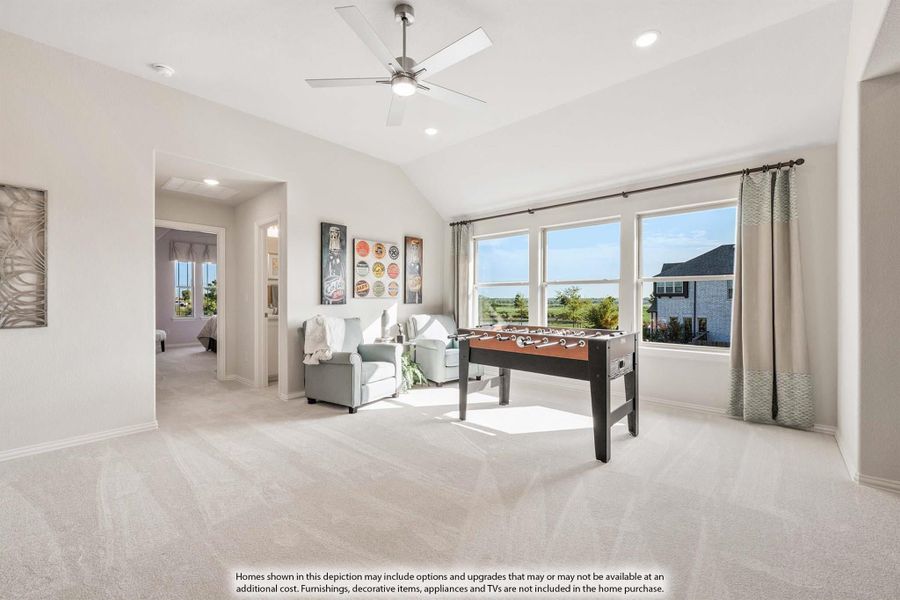 Bonus room with vaulted ceiling, ceiling fan, foosball table, and large windows with outdoor views