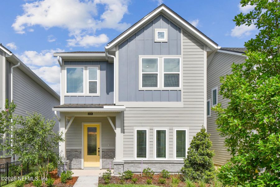 Front exterior of a new home in Granville at eTown 34', Jacksonville, FL, highlighting curb appeal (Image 1).