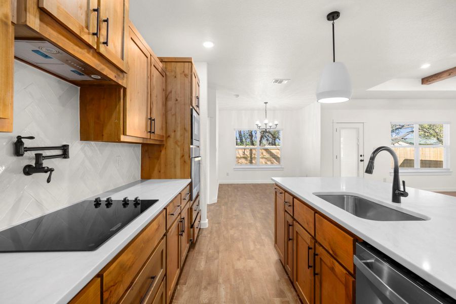 A well-lit kitchen with sleek appliances and ample counter space for culinary creations.