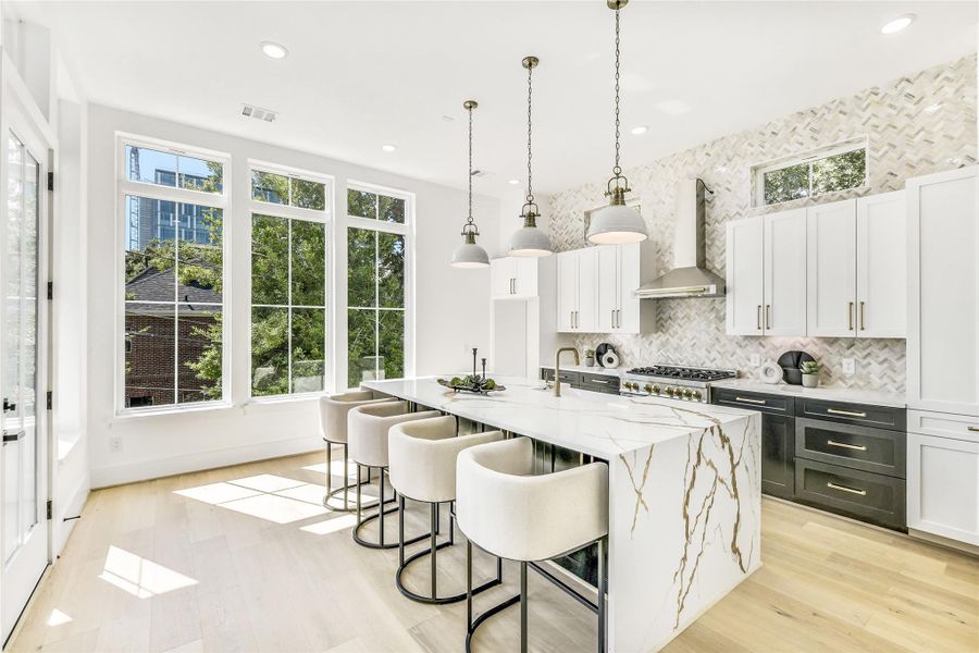 The perfect blend of form and function, this layout offers abundant counter space, custom drawer storage, and an oversized island ideal for meal prep, coffee chats, or evening glass of wine after rounds. Wide-plank white oak floors and large energy-efficient windows create a warm yet sophisticated backdrop that feels both modern andlivable.