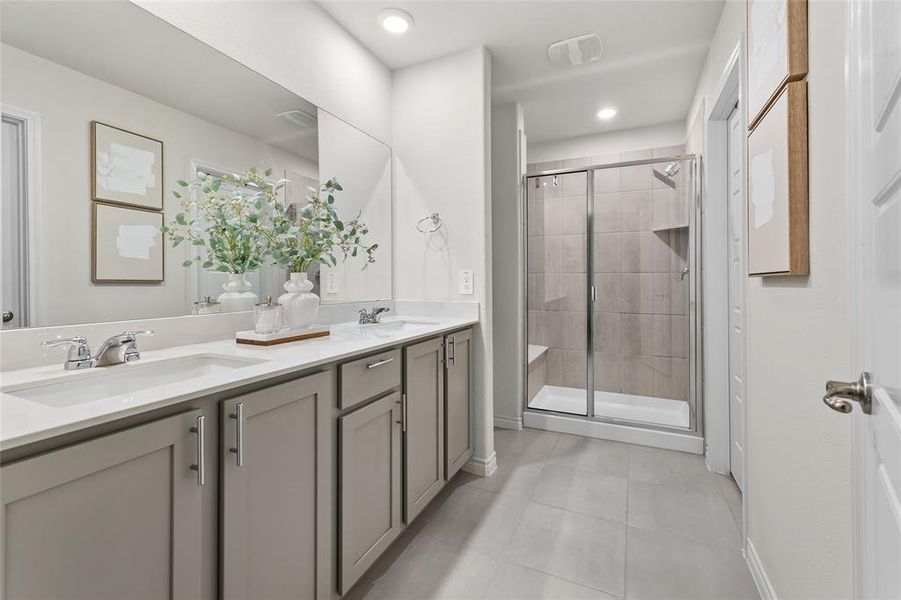 Full bathroom featuring a stall shower, double vanity, light tile patterned floors, and recessed lighting Full bathroom featuring a stall shower, double vanity, light tile patterned floors, and recessed lighting