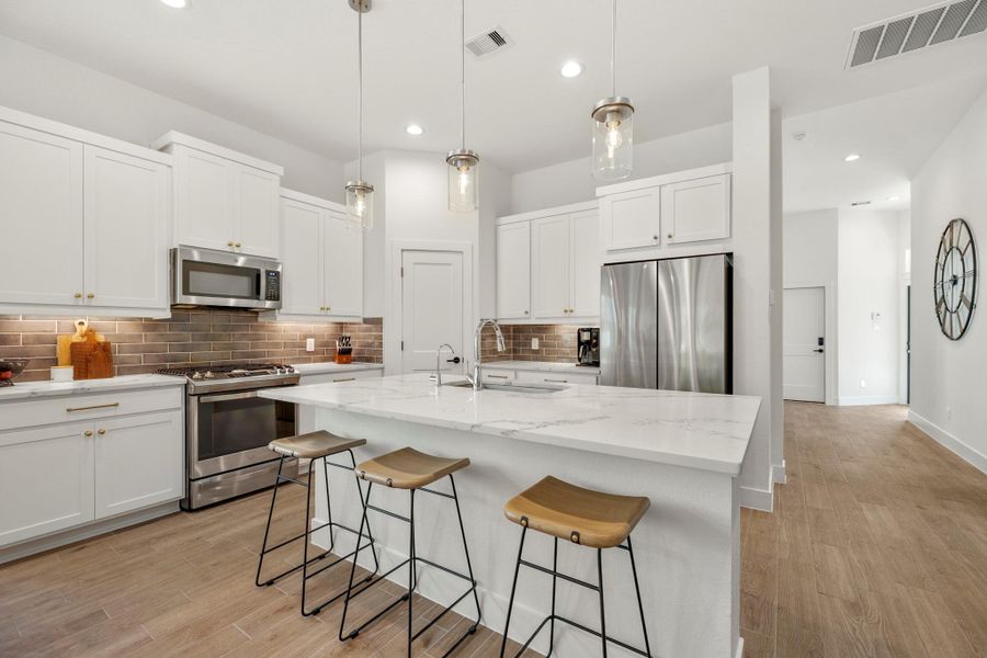 The space is bright and open, with stylish pendant lighting and a neutral color palette. The space is bright and open, with stylish pendant lighting and a neutral color palette.