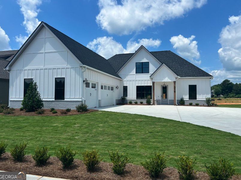 Front exterior of a new home in Mill Farms, Peachtree City, GA, highlighting curb appeal (Image 1).