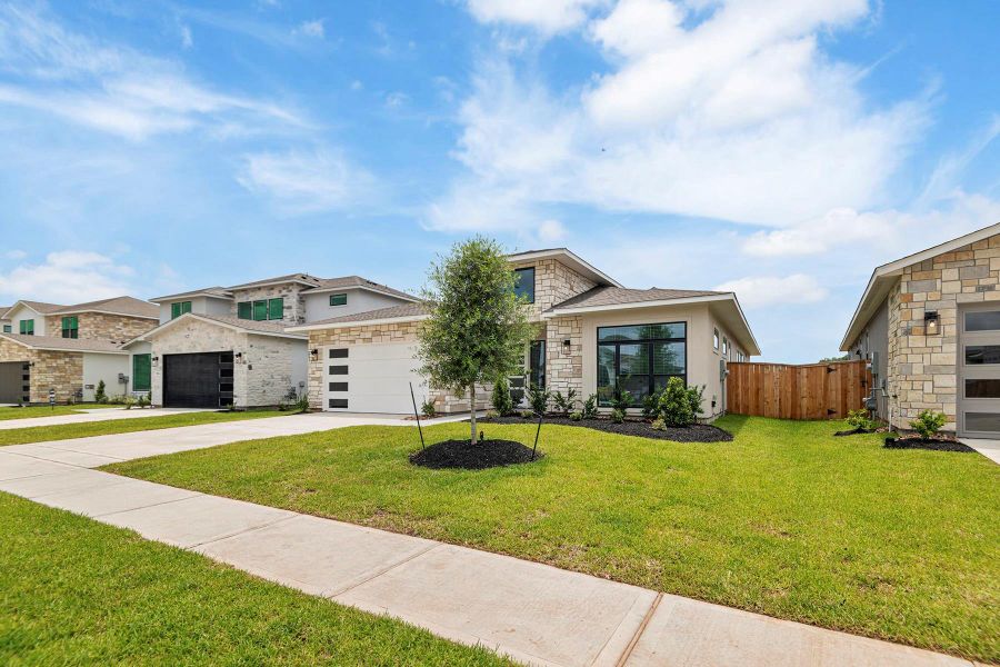 Front exterior of a new home in Hallimore Ranch, Rosenberg, TX, highlighting curb appeal (Image 2).