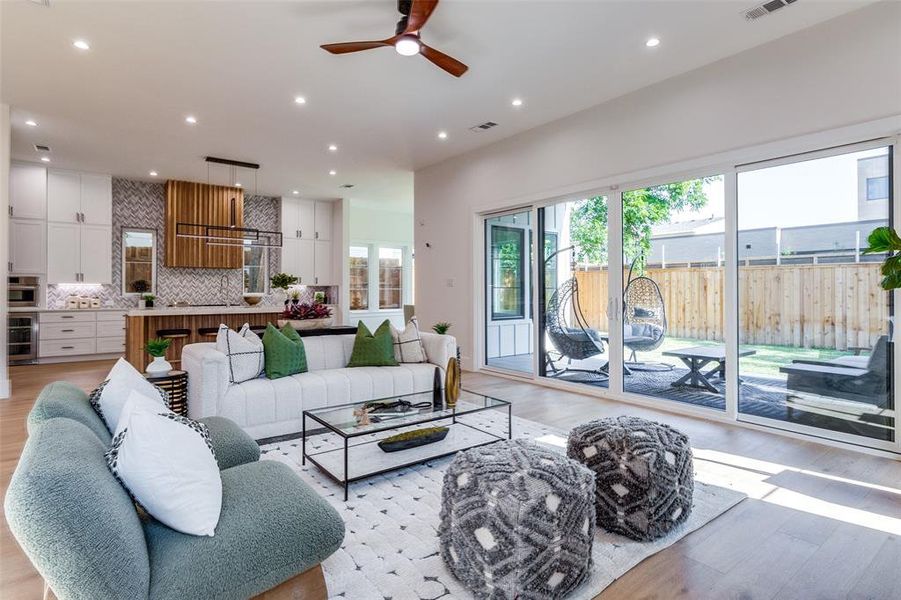 Living room with light hardwood / wood-style flooring and ceiling fan