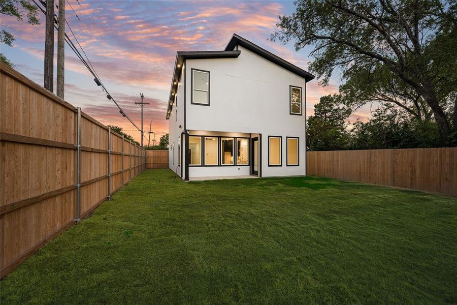 Back of house featuring stucco siding and a fenced backyard