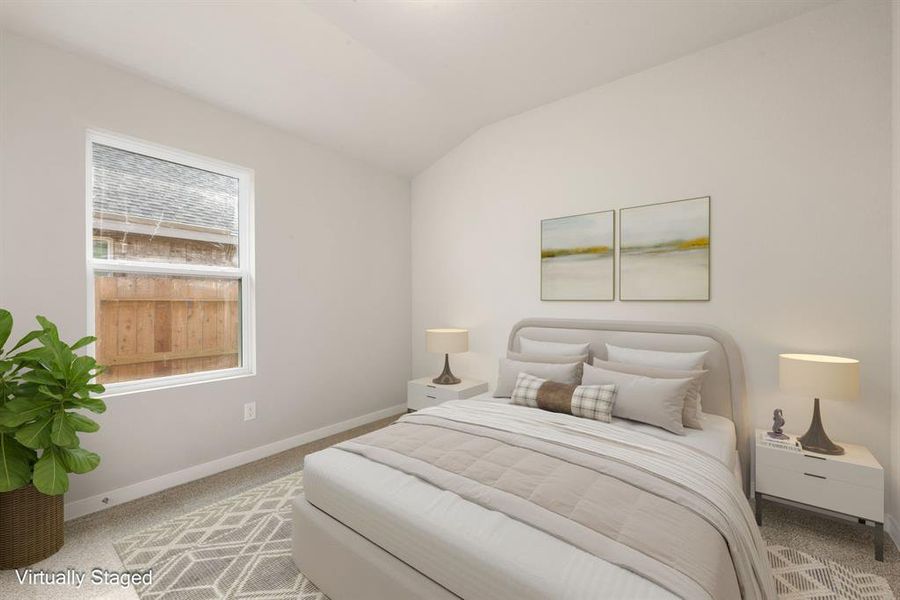 Secondary bedroom features plush carpet, neutral paint, and a large window with plenty of natural light.