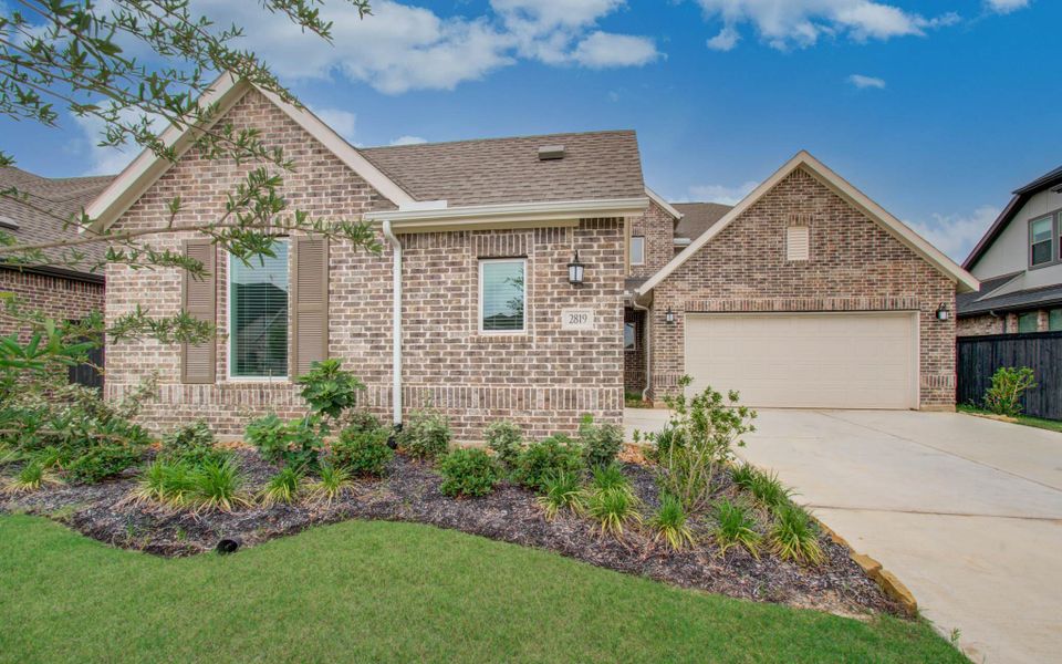 Front exterior of a new home in Harvest Green, Richmond, TX, highlighting curb appeal (Image 2).