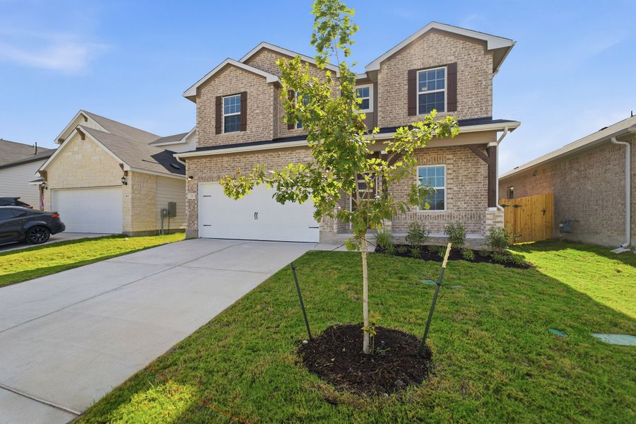 Front exterior of a new home in Sunfield, Buda, TX, highlighting curb appeal (Image 26).