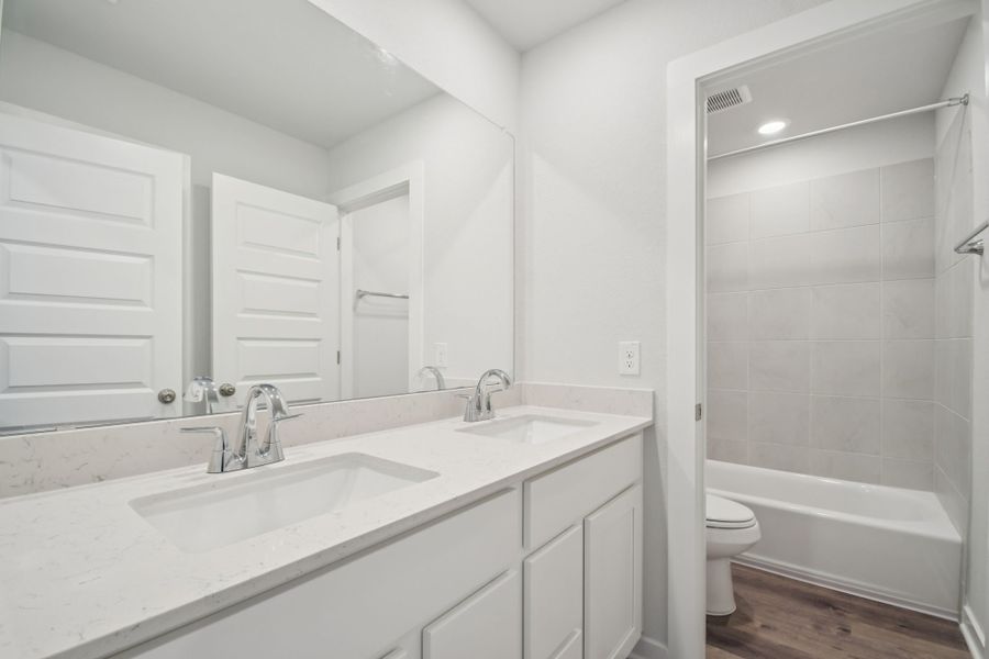 A bathroom with a sink toilet and bathtub.