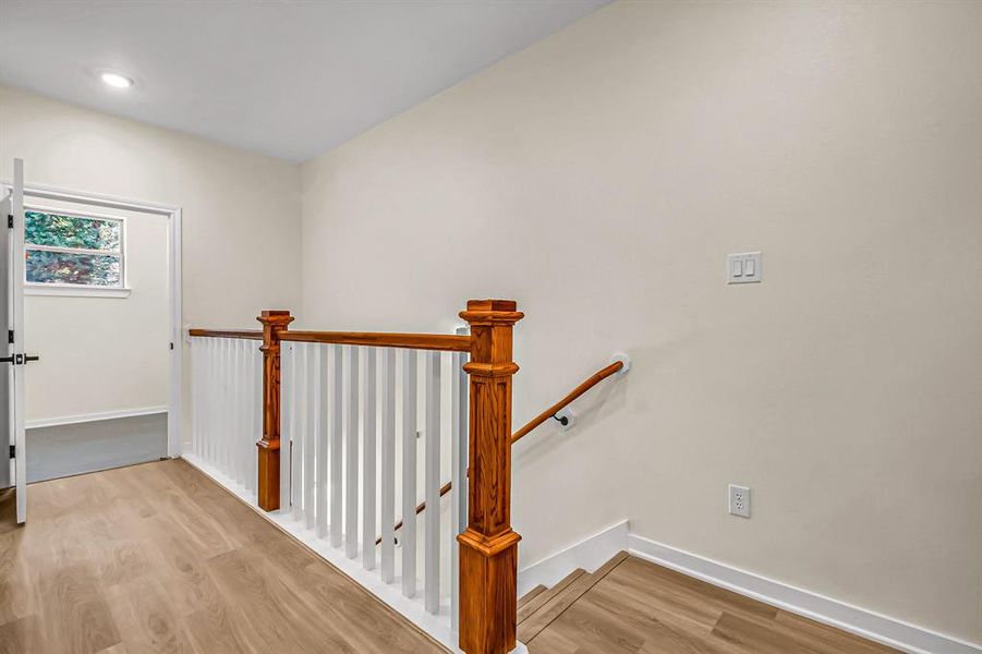 Second floor landing with access to the laundry room and three bedrooms.