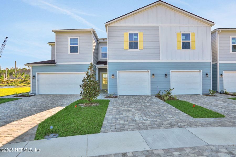 Front exterior of a new home in Brook Forest - Townhomes, St. Augustine, FL, highlighting curb appeal (Image 24).
