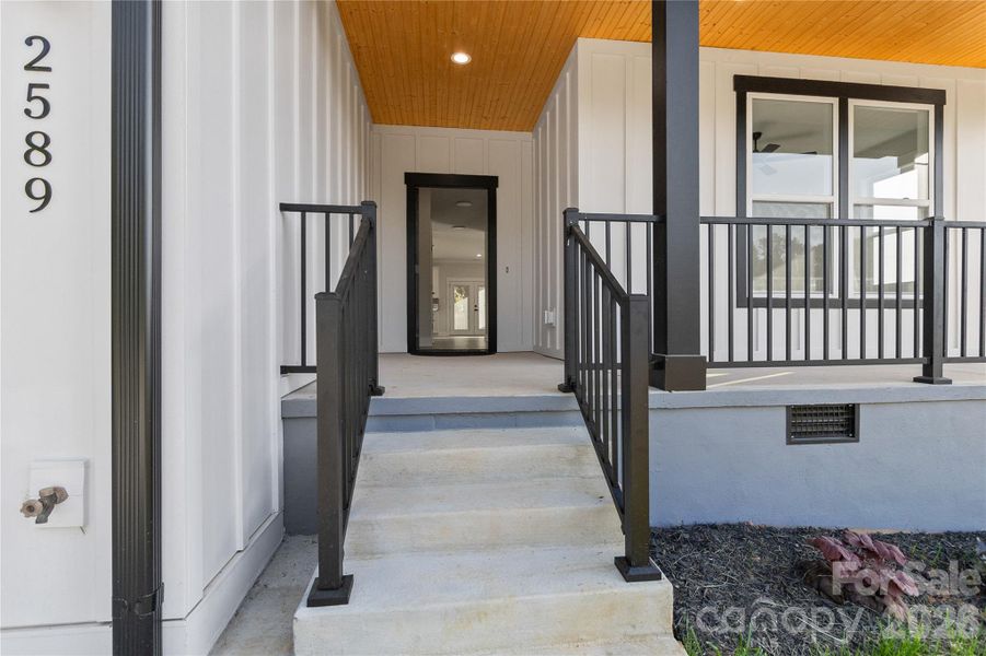 Gorgeous front patio covered and a wood ceiling