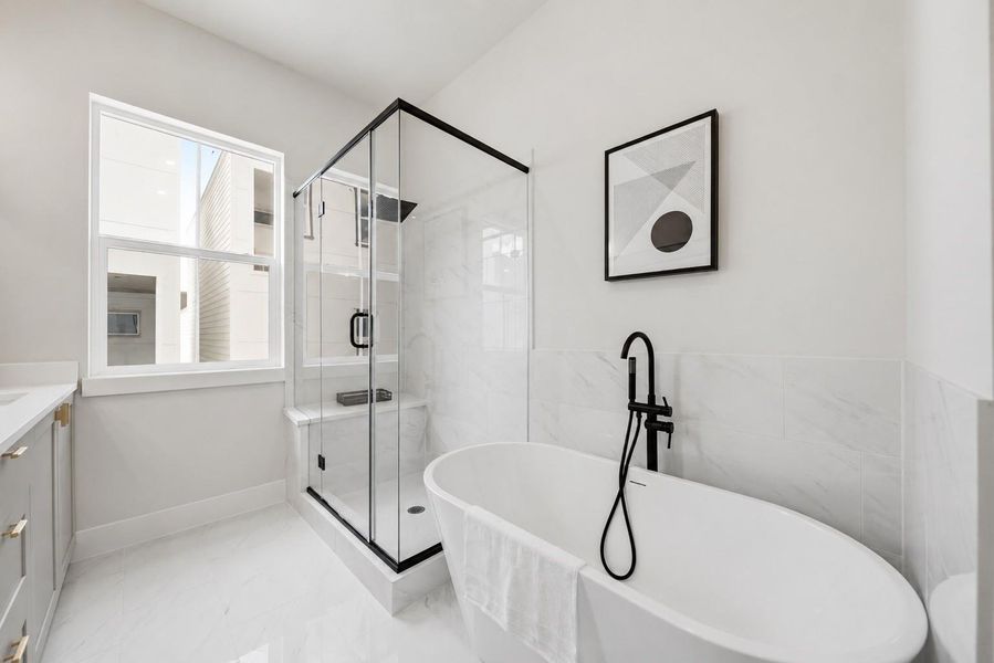 Primary bathroom with freestanding soaking tub and walk-in shower Primary bathroom with freestanding soaking tub and walk-in shower