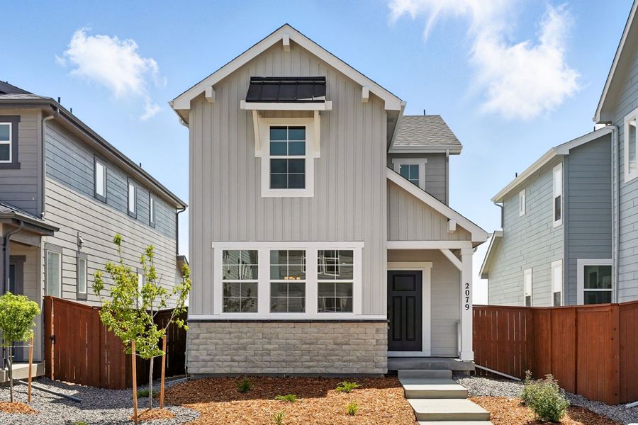 Front exterior of a new home in Farmlore, Brighton, CO, highlighting curb appeal (Image 1).