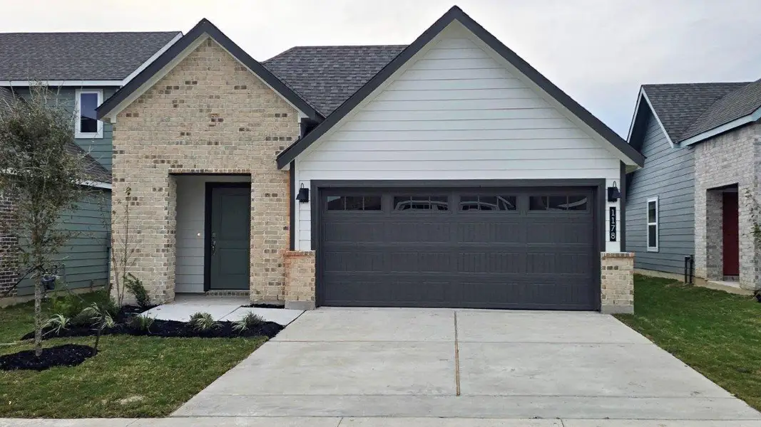 Front exterior of a new home in Midtown Reserve, College Station, TX, highlighting curb appeal (Image 1). Front exterior of a new home in Midtown Reserve, College Station, TX, highlighting curb appeal (Image 1).