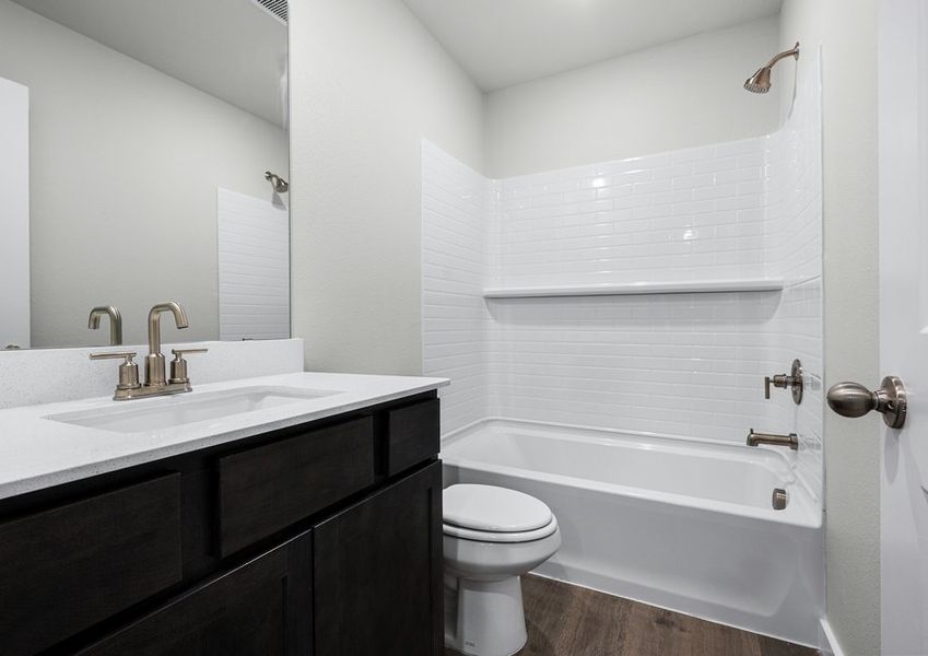 The secondary bathroom has a sprawling vanity space and a shower-tub combo. The secondary bathroom has a sprawling vanity space and a shower-tub combo.