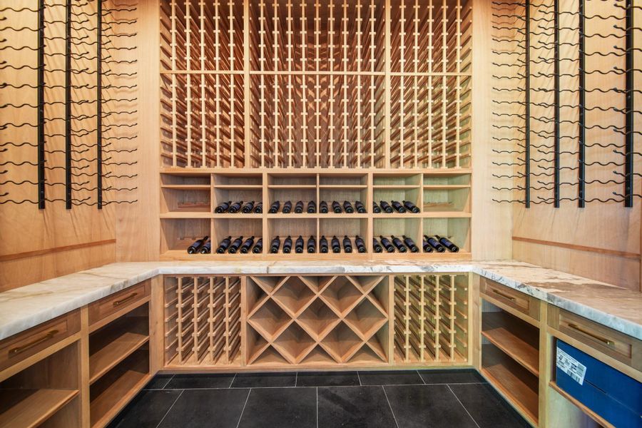 Massive temperature controlled custom wine room, which can hold over 500 bottles. Massive temperature controlled custom wine room, which can hold over 500 bottles.