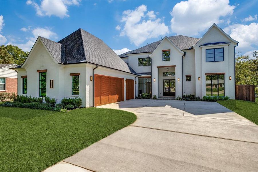 View of front facade with driveway, brick siding, a front yard, a shingled roof, and a garage View of front facade with driveway, brick siding, a front yard, a shingled roof, and a garage