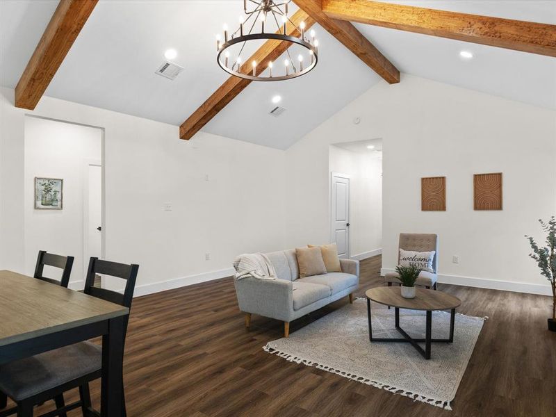 Living room with suspended lighting and dark wood-style floors