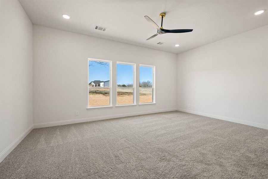 Unfurnished room featuring ceiling fan, recessed lighting, carpet flooring, visible vents, and baseboards