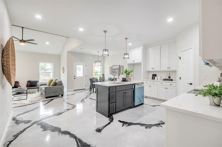 Kitchen with granite countertops, stainless steel appliances,  white cabinets with soft close handles, decorative backsplash, and sink