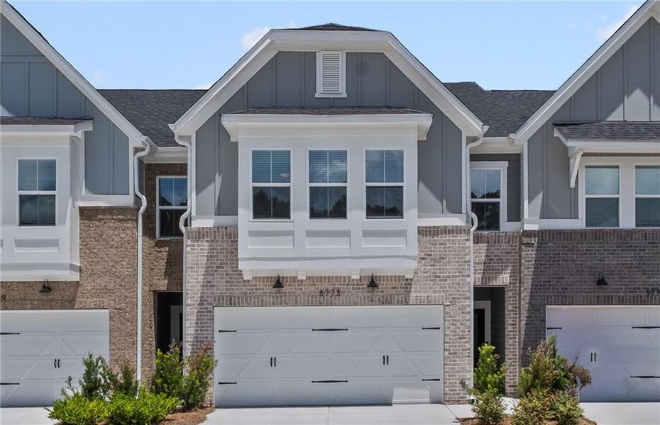 Front exterior of a new home in Adler Springs, Powder Springs, GA, highlighting curb appeal (Image 1).