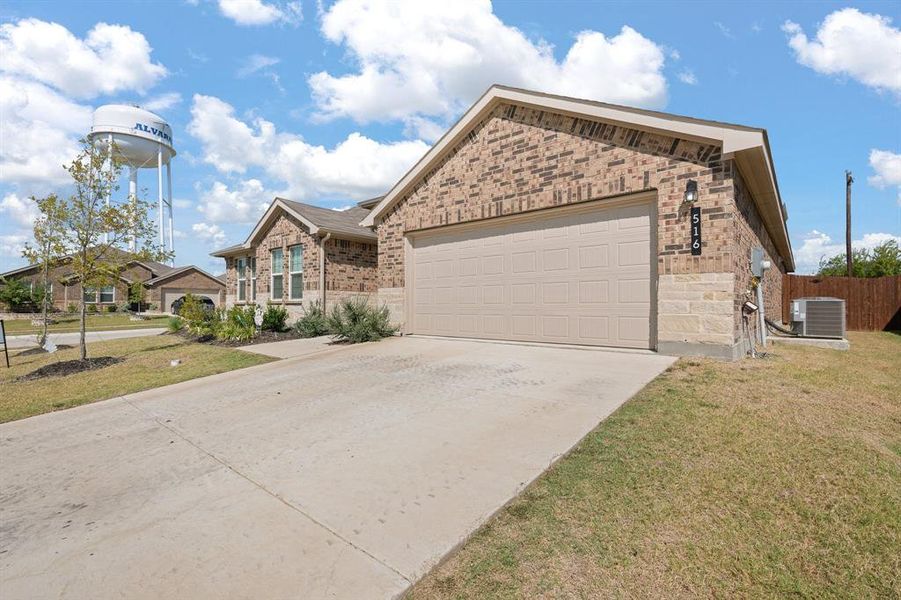 Front exterior of a new home in The Parks of Alvarado, Alvarado, TX, highlighting curb appeal (Image 24).