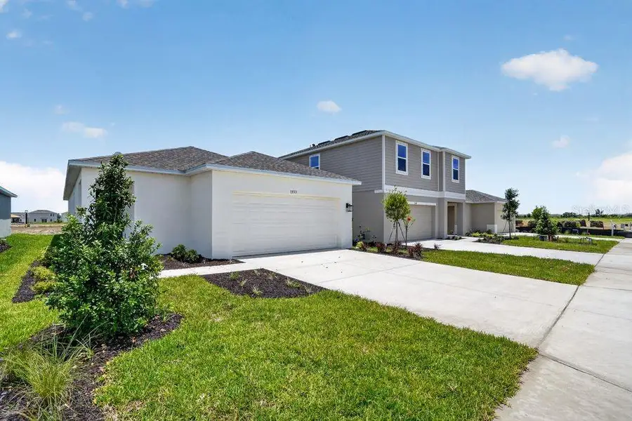 Front exterior of a new home in Firethorn, Parrish, FL, highlighting curb appeal (Image 18).