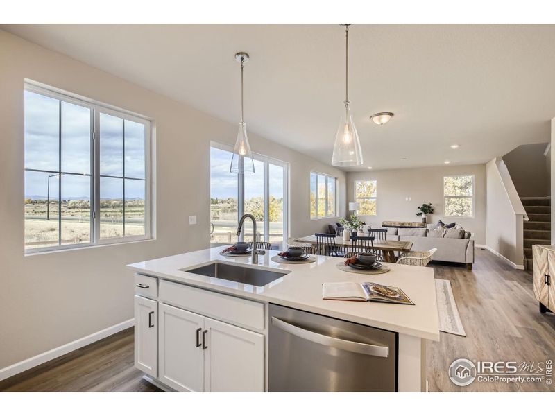 Kitchen to great room *Photo not of actual home, but same floorplan and style*