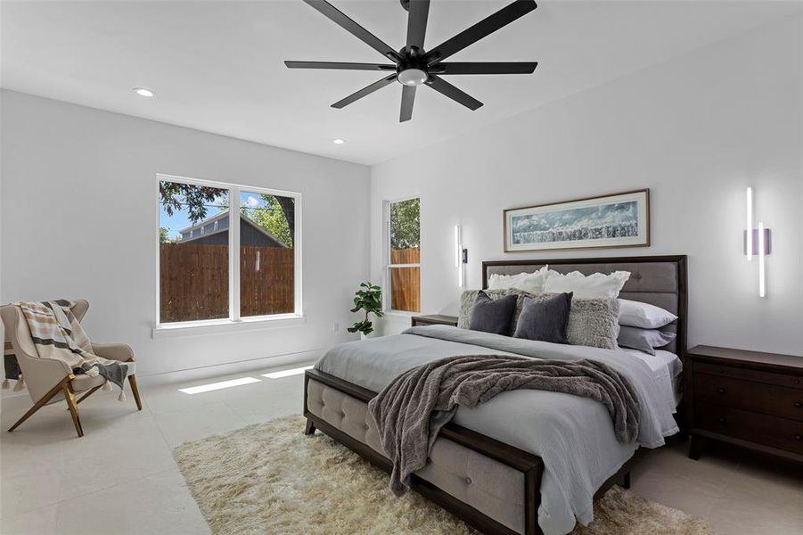 Bedroom with ceiling fan and light tile patterned flooring