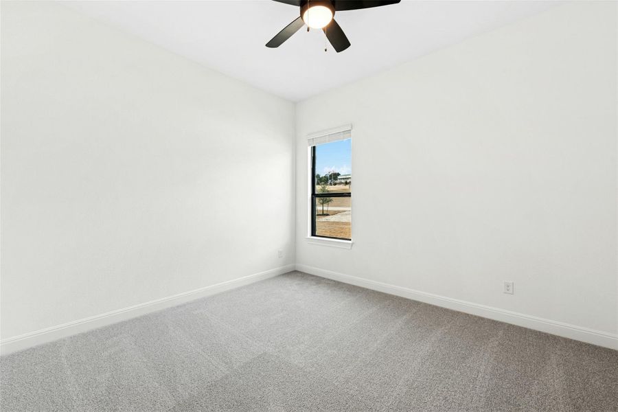 Spare room with carpet floors and ceiling fan