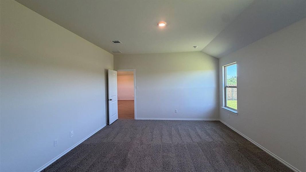 Neutral wall finishes, recessed lighting, and a single window offering natural light