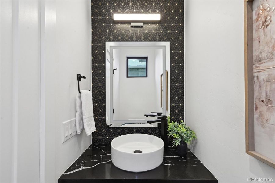 Main level powder room with LED backlit mirror