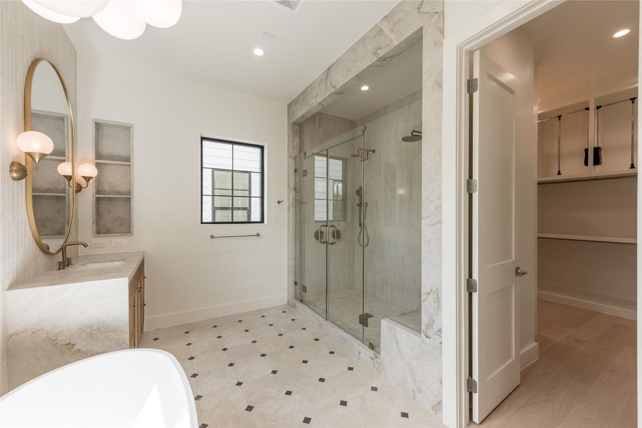 A seamless transition from the primary bath leads into the generous walk in closet, with custom built in shelving extending the suite’s thoughtful design into everyday function. A seamless transition from the primary bath leads into the generous walk in closet, with custom built in shelving extending the suite’s thoughtful design into everyday function.