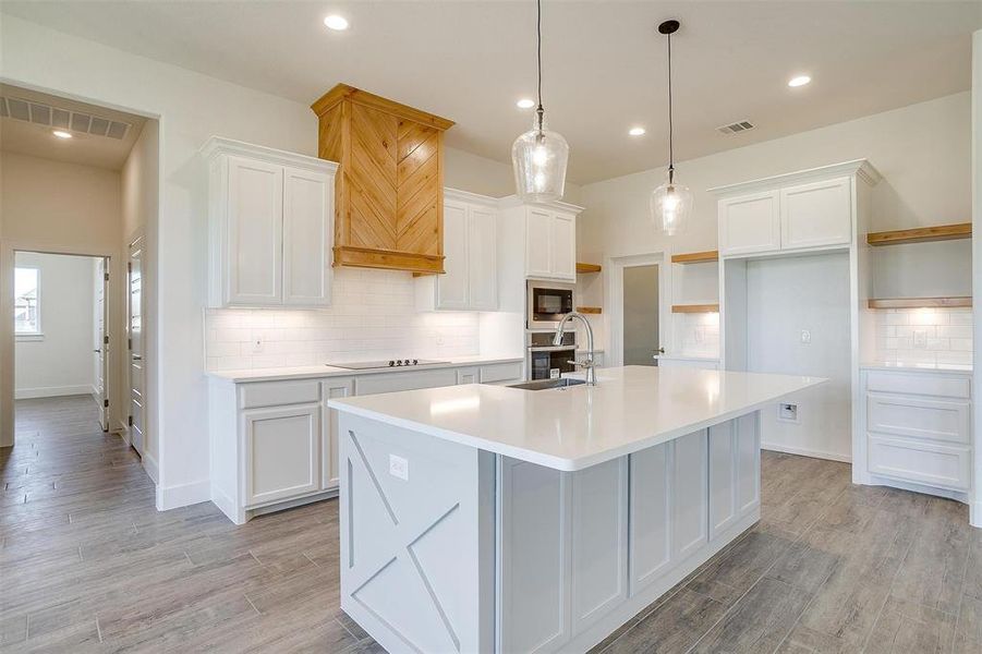 Kitchen with black appliances and white cabinets