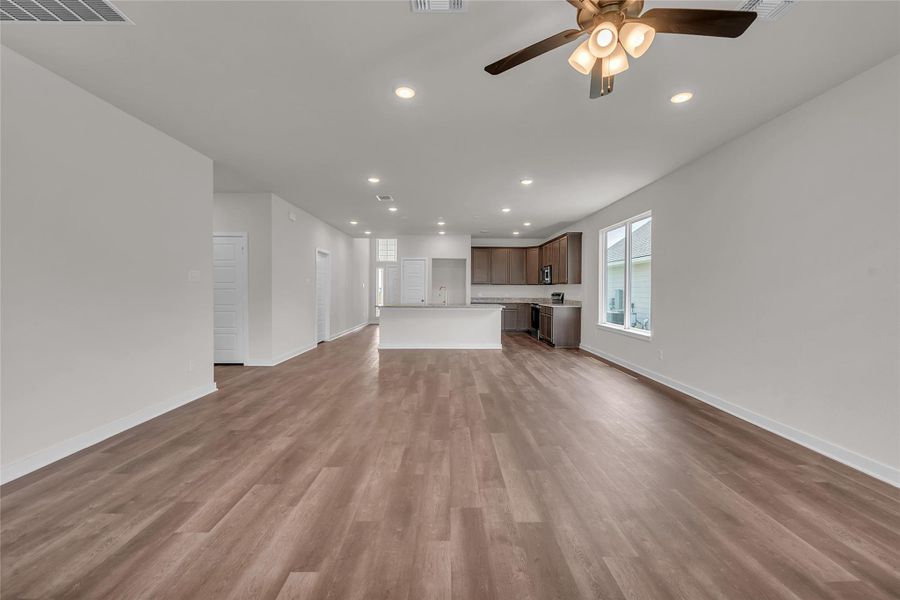 Unfurnished living room featuring recessed lighting, dark wood finished floors, and ceiling fan Unfurnished living room featuring recessed lighting, dark wood finished floors, and ceiling fan