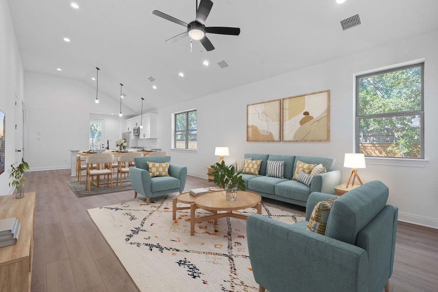Living room featuring high vaulted ceiling, recessed lighting, light wood-style floors, and ceiling fan