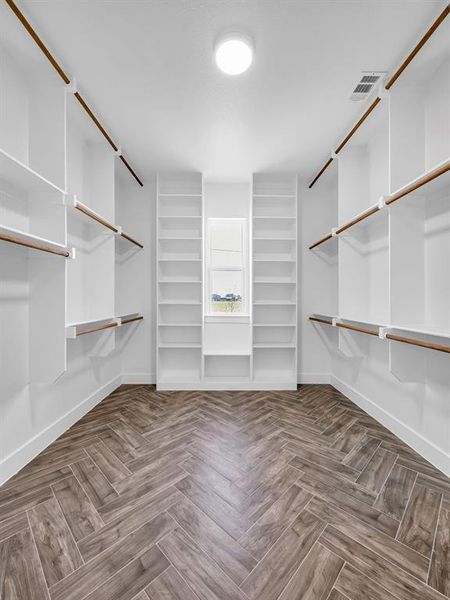 Spacious closet featuring parquet flooring