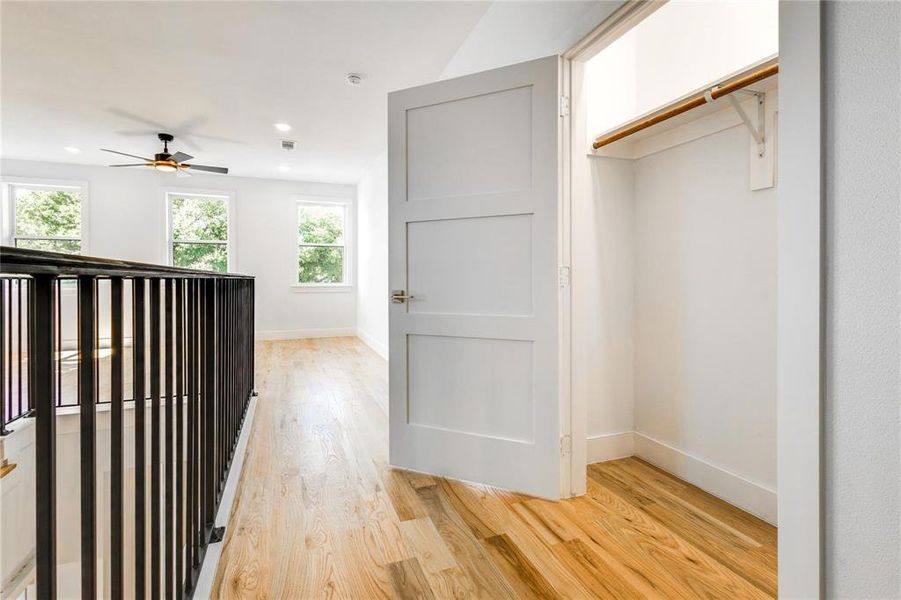 Hall with light hardwood / wood-style floors