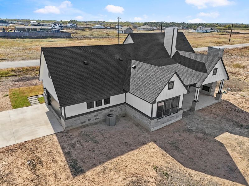 Newly constructed residence presenting a blend of shingle roofing and stone siding, poised in a spacious setting. Newly constructed residence presenting a blend of shingle roofing and stone siding, poised in a spacious setting.